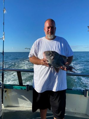 a man holding a fish in the water
