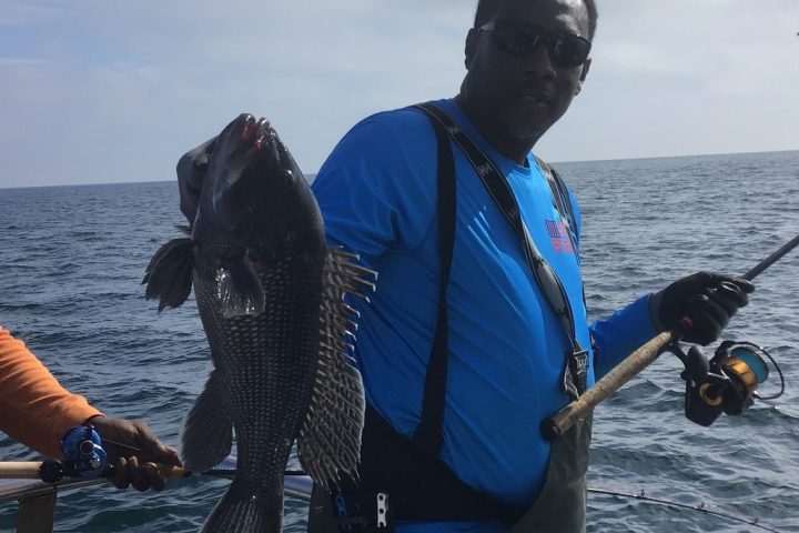 a person standing next to a body of water