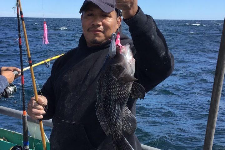 a person standing next to a body of water