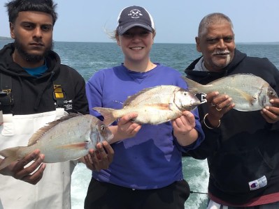 Varavara Rao holding a fish in the water