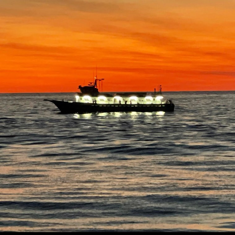a small boat in a large body of water