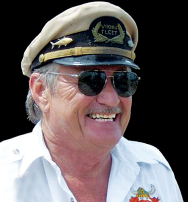 Smiling man in white shirt and captain's hat with 'Viking Fleet' text.